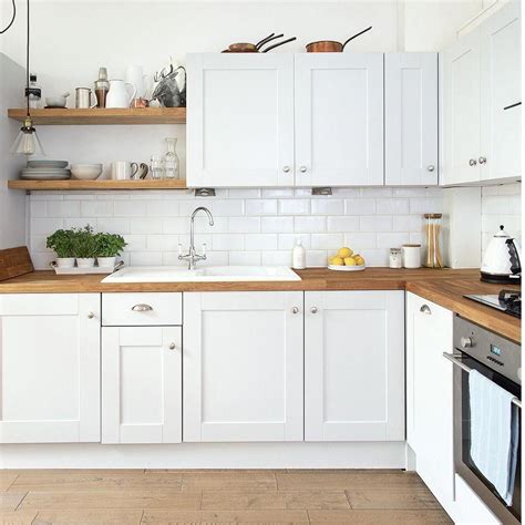 Modern white kitchen with wooden floor and worktops #kitchencountertopswithwhitecabinetsbutcherb ...