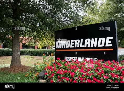 A logo sign outside of a facility occupied by Vanderlande Industries in ...