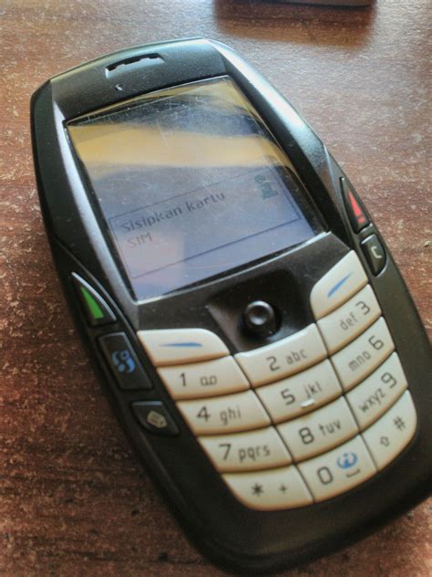 a cell phone sitting on top of a wooden table