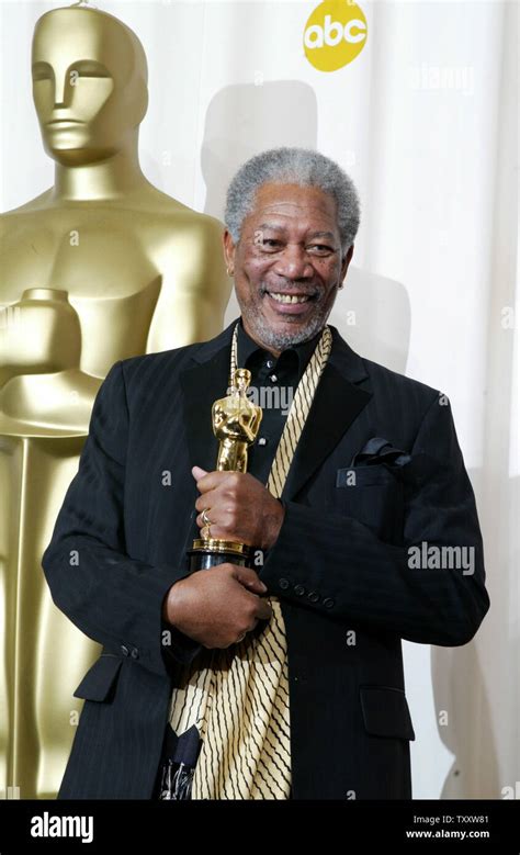 Morgan Freeman holds his statue after winning the best supporting actor ...