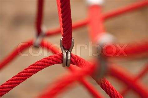 Thick red rope with knots on faded | Stock Photo | Colourbox