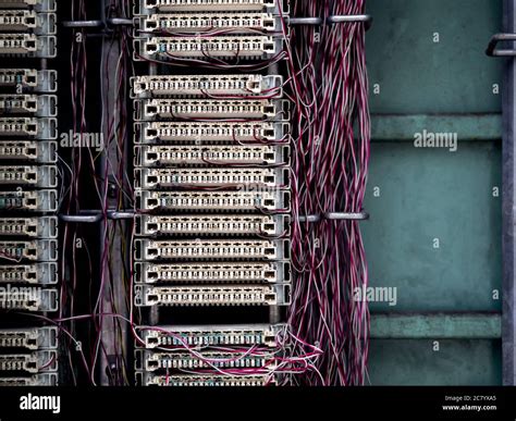 Old analog telephone switchboard system connection panel with wire fixed-line in old cabinet ...