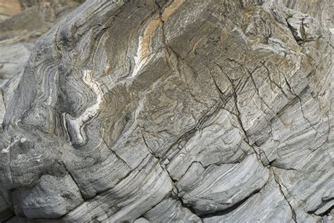 Gneiss is metamorphic, meaning that its structure has been altered by volcanic heat and pressure ...