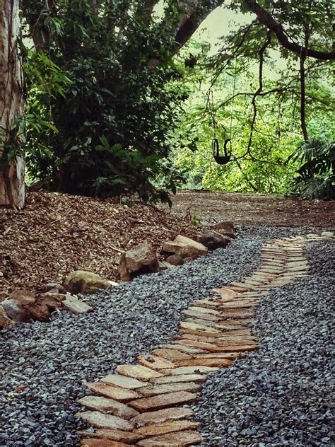 Recycled bricks and 20mm of blue metal gravel were used to make a path ...