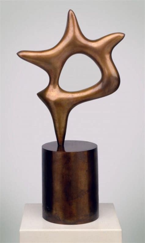 a bronze sculpture sitting on top of a white pedestal