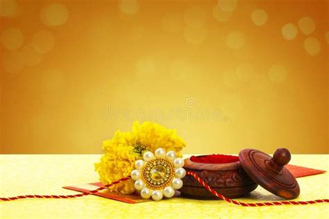 a wooden bowl with some flowers on top of it next to a string and bead