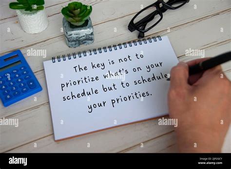 Inspirational quote text on white notepad about priorities and scheduling. Inspirational concept ...