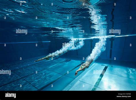 Two female swimmers dive start in an open air Olympic swimming pool Stock Photo - Alamy