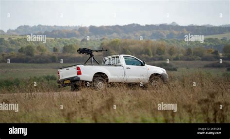 white toyota hilux pickup truck converted with an army large calibre ...