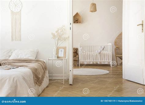 White Scandinavian Bedroom with Door Open To Nursery Stock Image - Image of condo, door: 130740119