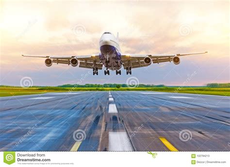 Passenger Airplane Landing at Sunset on a Runway. Stock Image - Image of sunset, plane: 102794213