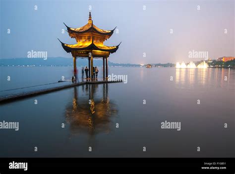 The pagoda in the West Lake of Hangzhou illuminated at night Stock ...