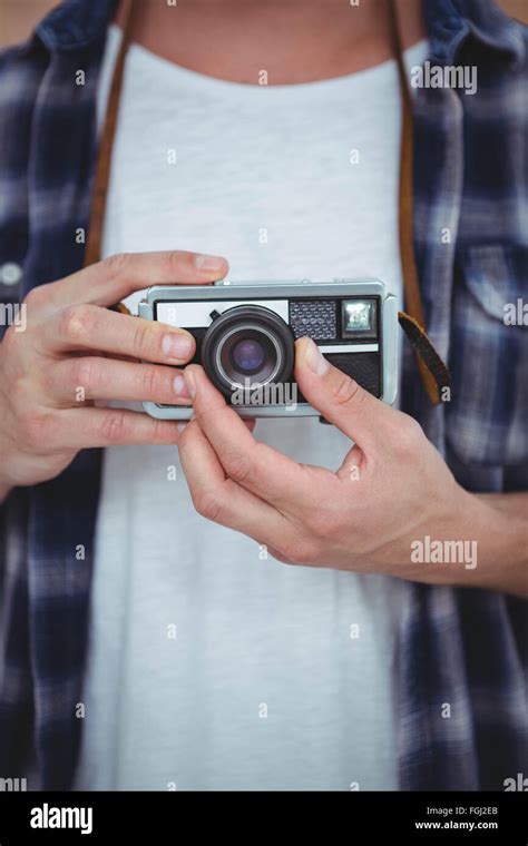 View of masculine hands holding a retro camera Stock Photo - Alamy