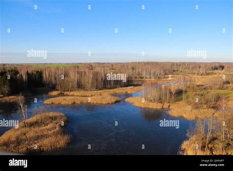 The National park with karst lakes and flooded old grass meadow in Kirkilai, Lithuania. Walk at ...