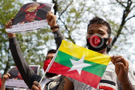 Anti-coup protesters hold Myanmar national flag - The Shot