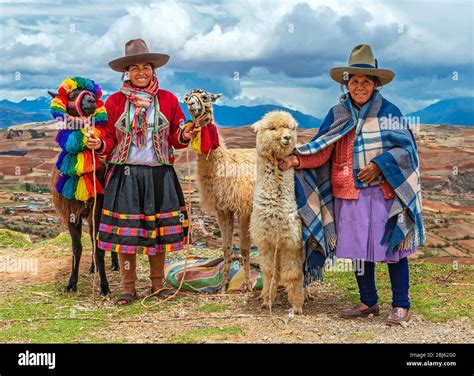 A rural portrait of Quechua Indigenous Women in traditional clothes with their domestic animals ...