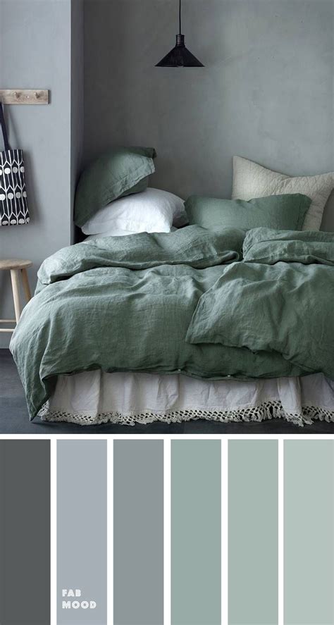 a bedroom with gray walls and green bedding