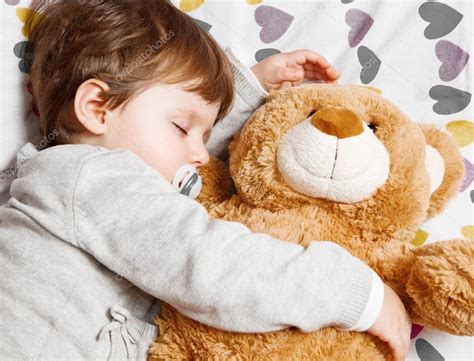 Child sleeping with teddy bear Stock Photo by ©lsantilli 127983932