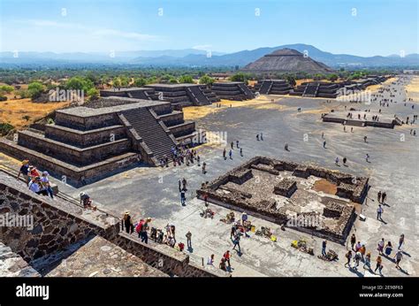 Tourists climbing the Moon Pyramid with Sun Pyramid and Alley of the Dead near Mexico City ...