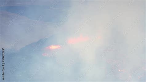 Volcano vent eruption with ejected lava river flowing down valley in ...