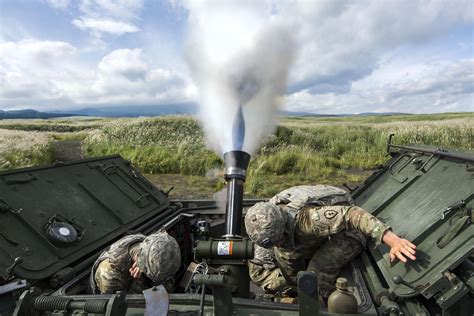 Mortar Blast. Soldiers use a 120 mm mortar system on an M1129 mortar ...