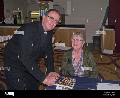 Reverend Richard Coles signs a copy of his autobiography for a female fan, Northampton, UK Stock ...