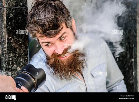 brutal photographer with camera. Mature hipster with beard. Bearded man. retro photographic ...