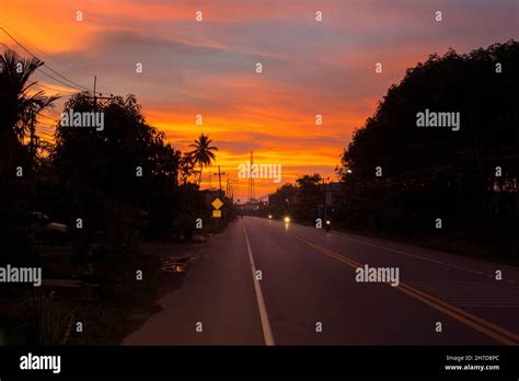 The beautiful silhouette sunset above asphalt road and environment Stock Photo - Alamy