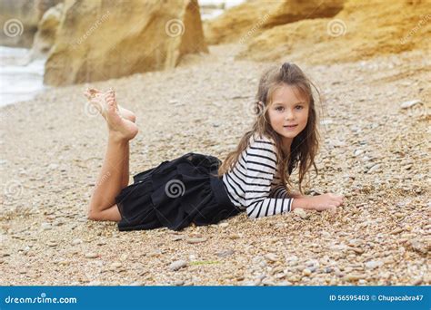 Child Girl Is Wearing Stripped Dress On The Beach Stock Photo - Image ...