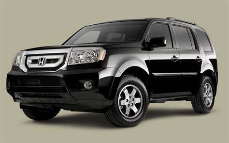 the front end of a black honda pilot suv parked on a gray background with no people around it