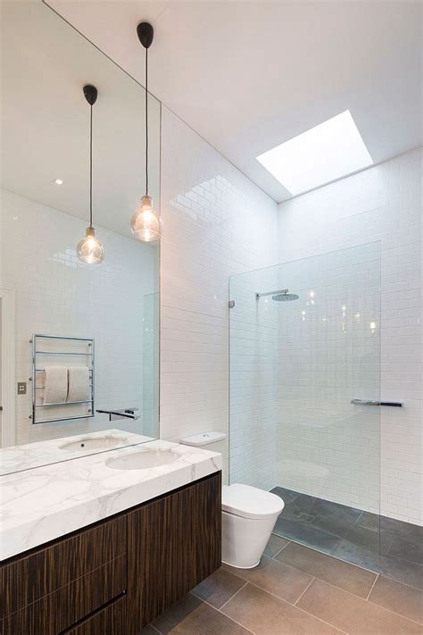 Skylight brings natural light into white, contemporary bathroom - Decoist