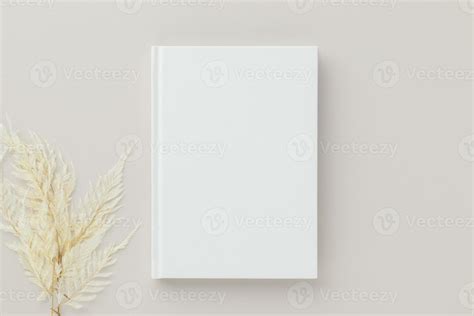 White book blank cover mockup on a beige background with dry flower ...