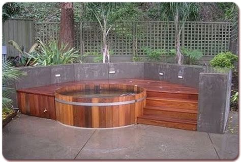 built in hot tub | Another traditional wood hot tub with steps and lighted surround wall. | Back ...