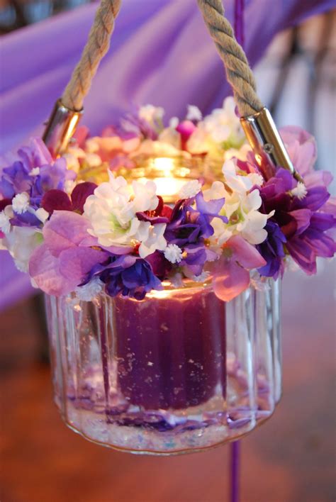 Nice purple flower arrangement with candle | Purple flower arrangements ...