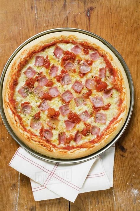 Ham, cheese and tomato pizza - Stock Photo - Dissolve