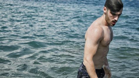 Young Man Standing on a Beach Alone Stock Image - Image of muscle, solitary: 122462779