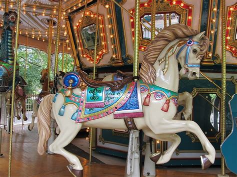 Royalty-Free photo: White, blue, and brown horse carousel | PickPik