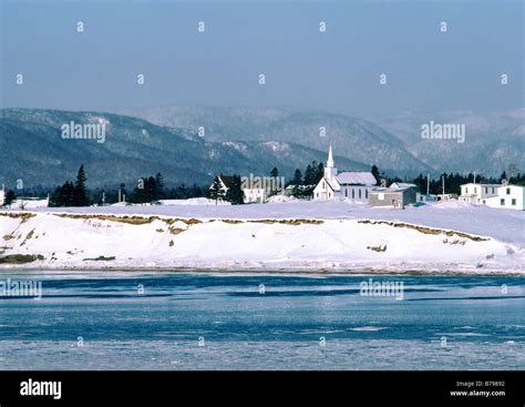 a winter scene at Ingonish Cape Breton Island nova Scotia Canada with snow and a church as well ...