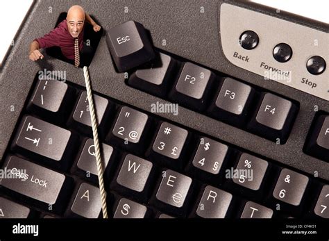 Businessman escaping from Escape key in a computer keyboard Stock Photo ...