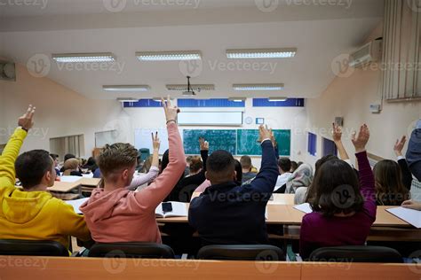 Raised hands and arms of large group of people in class room 11573784 ...