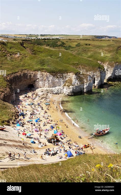 Yorkshire beach; people sunbathing on a hot sunny day in summer, Flamborough beach, Flamborough ...