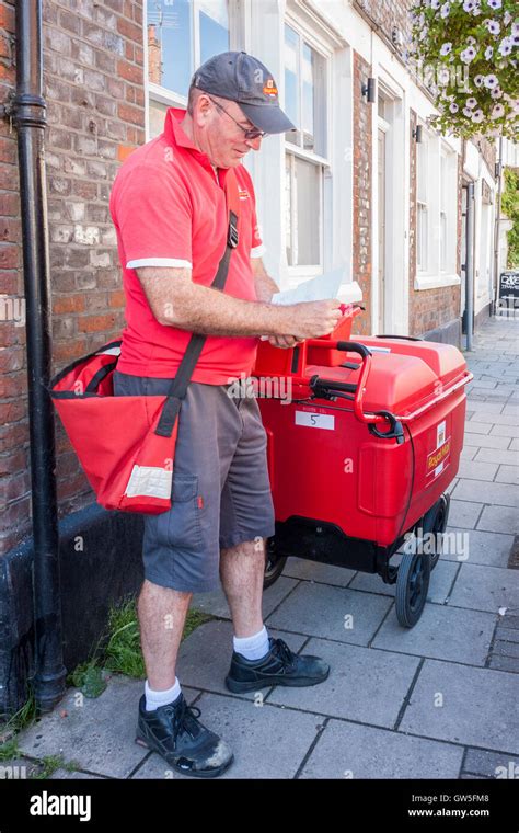 Royal Mail postman on delivery round. England, GB, UK Stock Photo ...