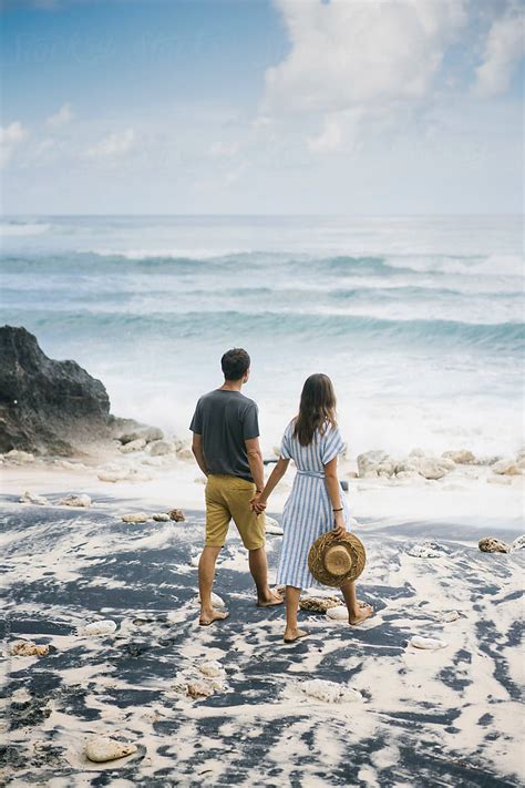 "Romantic Couple Holding Hands On Exotic Beach" by Stocksy Contributor "Dreamwood Photography ...