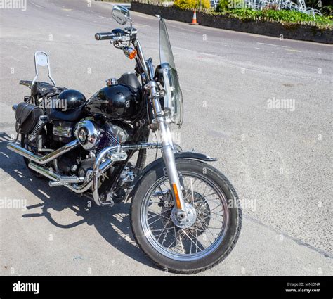 black street bob harley davidson motorbike or motocycle parked on the roadside Stock Photo - Alamy