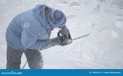 View of Sculptor Carving Ice. Movement. Cut Ice with a Chainsaw. Cut ...