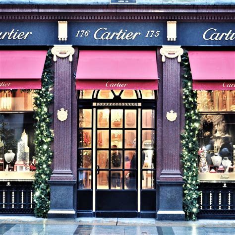 a store front with pink awnings and christmas decorations on the ...