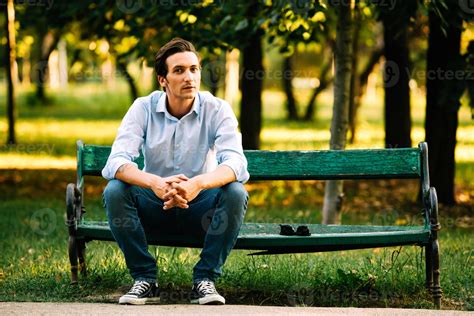 handsome adult man sitting on bench 1106094 Stock Photo at Vecteezy