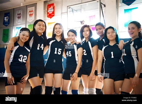 Portrait of teenage girls volleyball team at court Stock Photo - Alamy