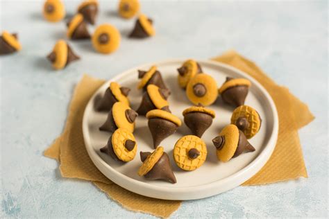 These candy acorn cookies are made with Nutter Butter Bites or Mini Nilla Wafers along with ...