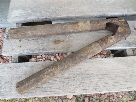 Livestock dehorning primitive ranch tool with wood handles